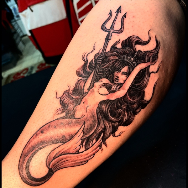 Fineline blackwork or black and grey mermaid pinup tattoo with trident