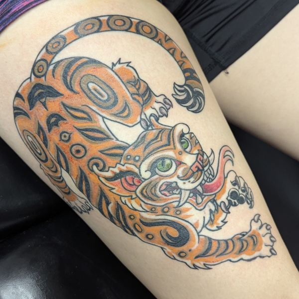 Orange Brown and Black traditional tiger tattoo on the upper leg