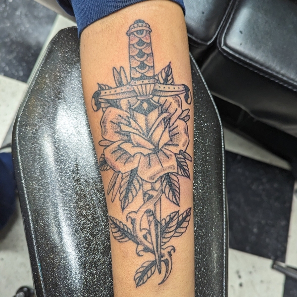 Custom tattoo design option picked from a special request flash sheet of roses and daggers