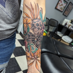 Skeleton Gardener with floral forearm tattoo